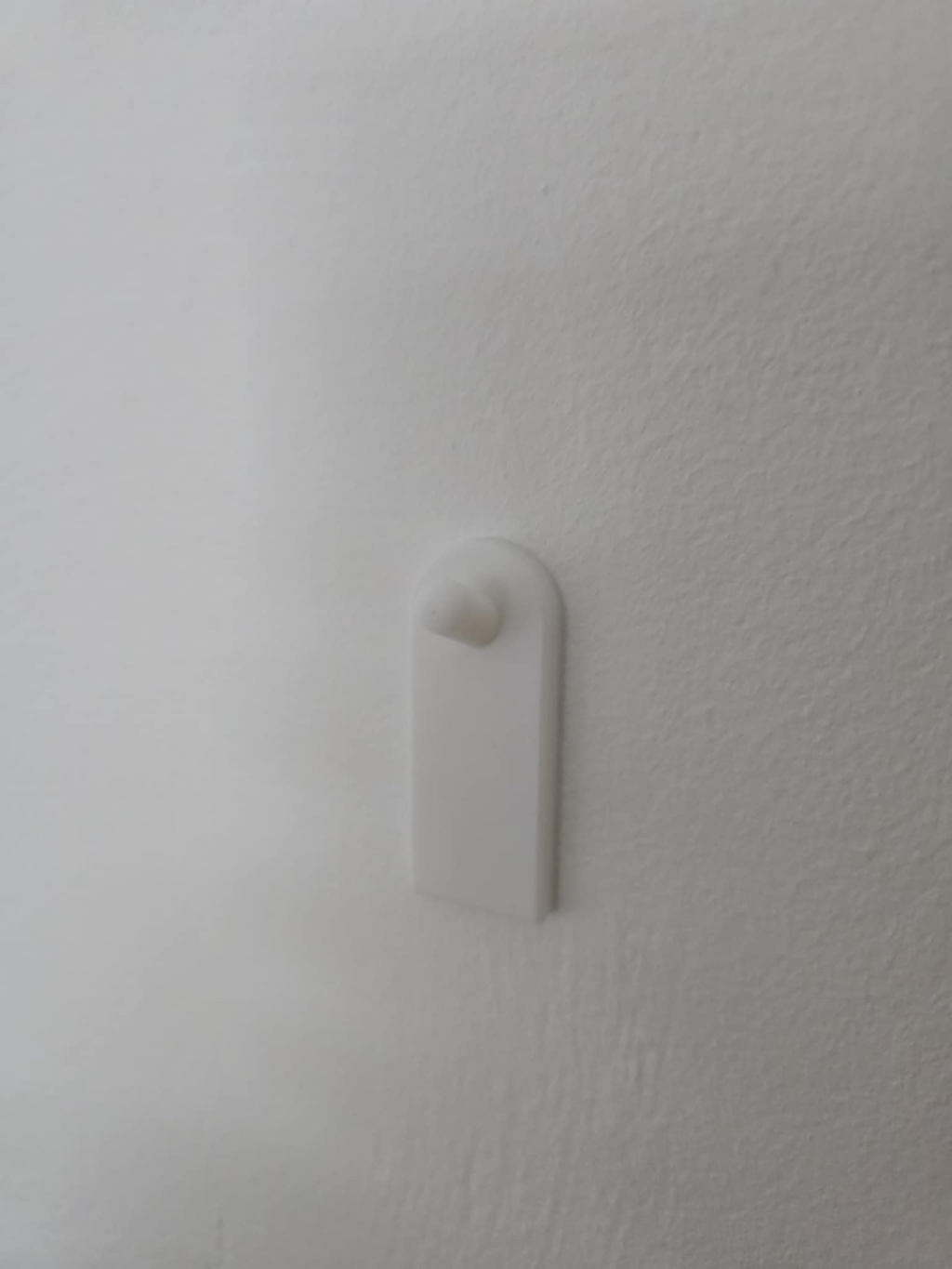 Flush wall hook using adhesive