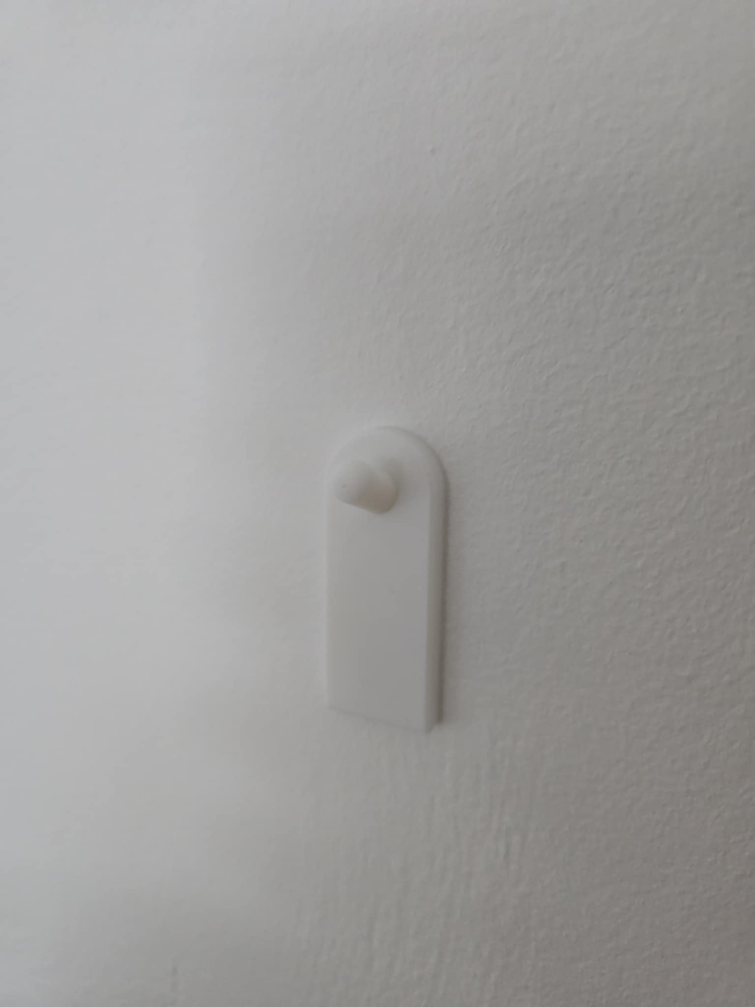 Flush wall hook using adhesive