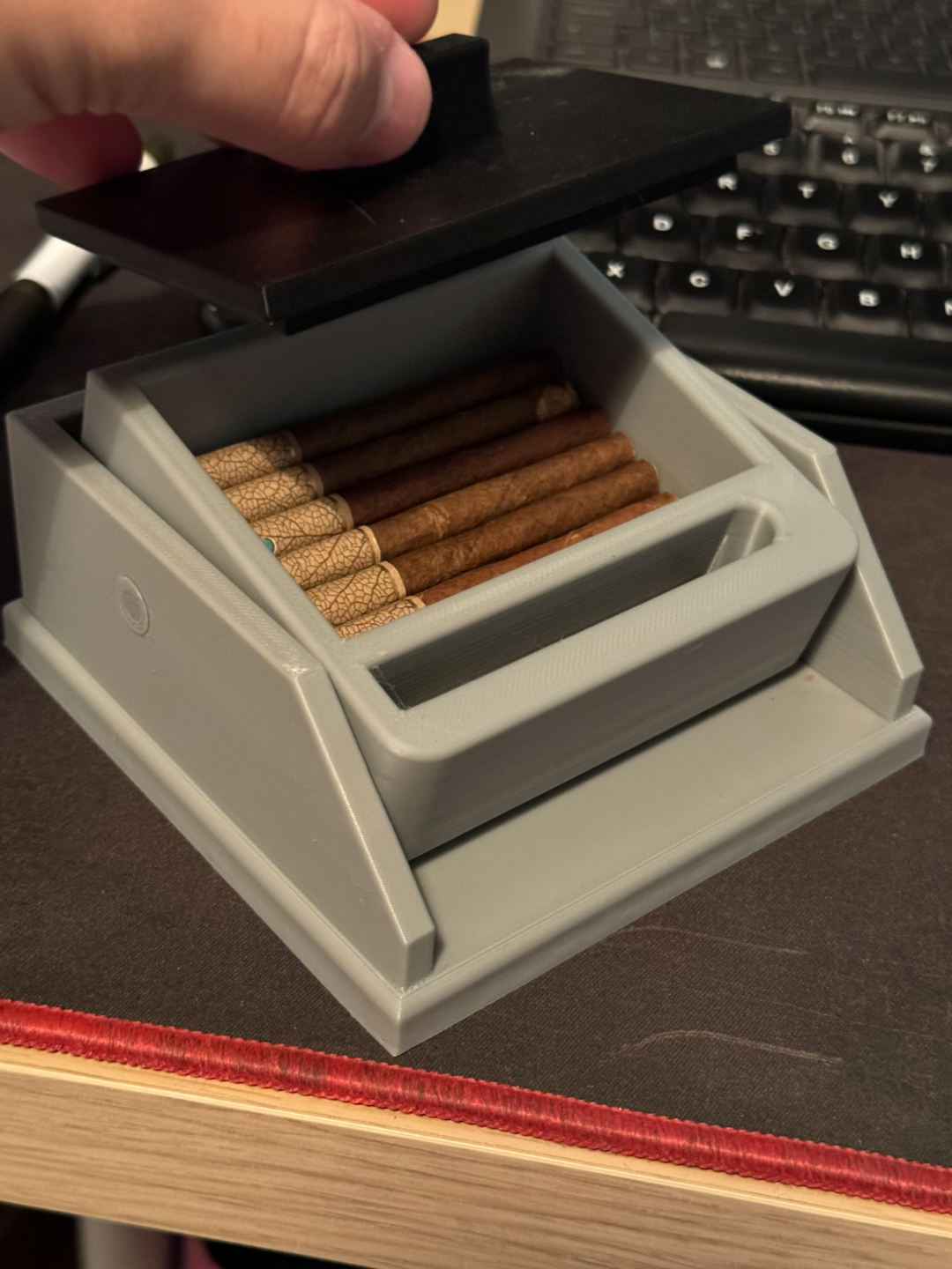 Cigarette box with lift feature