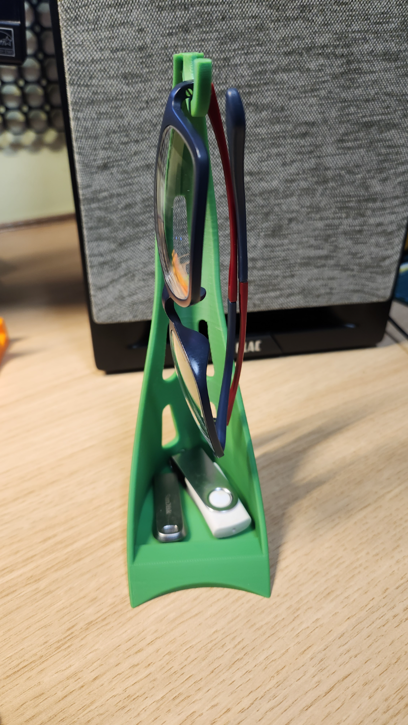 Glasses holder/stand with small storage at bottom.