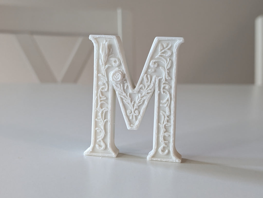 Standing Letter M in a Gypsum Floral Style