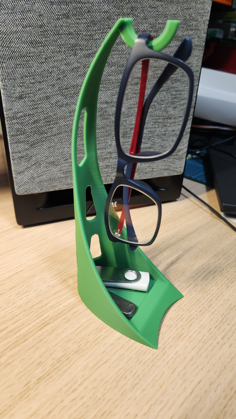 Glasses holder/stand with small storage at bottom.