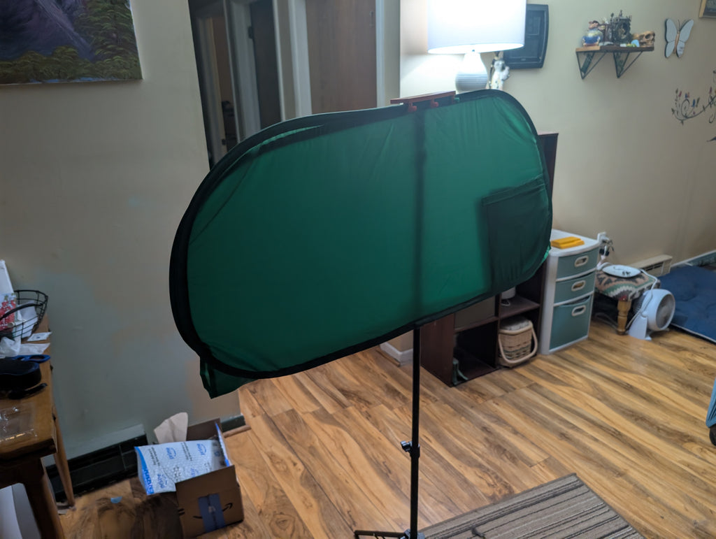 Tripod mounted green screen holder clip