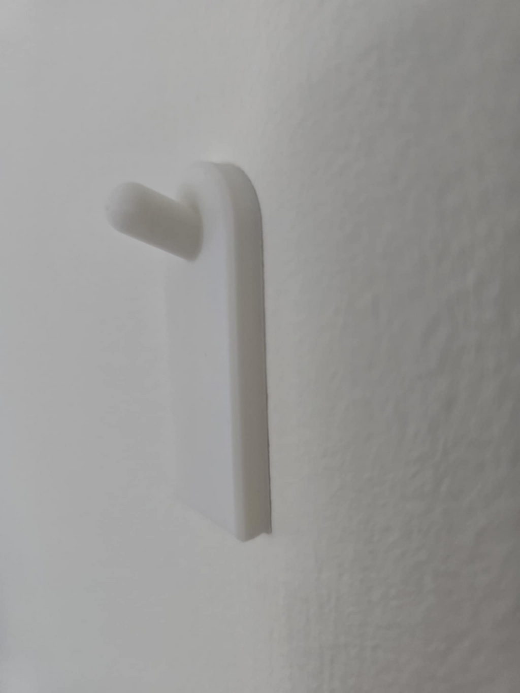 Flush wall hook using adhesive