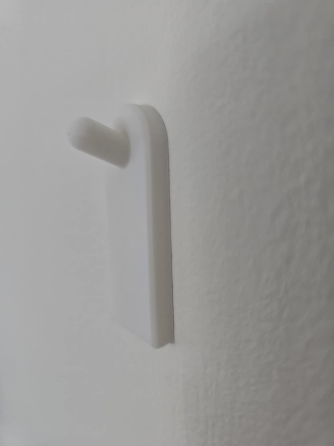 Flush wall hook using adhesive
