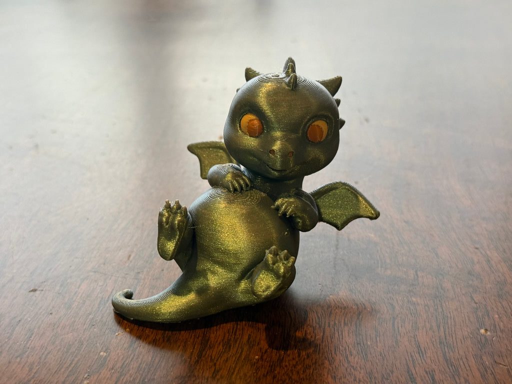 Adorable lounging baby dragon