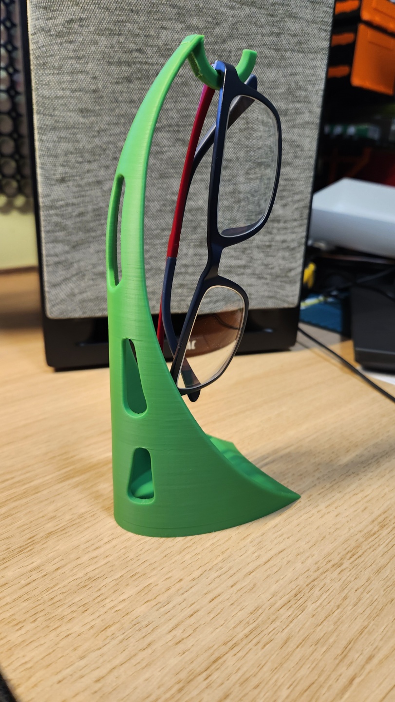 Glasses holder/stand with small storage at bottom.