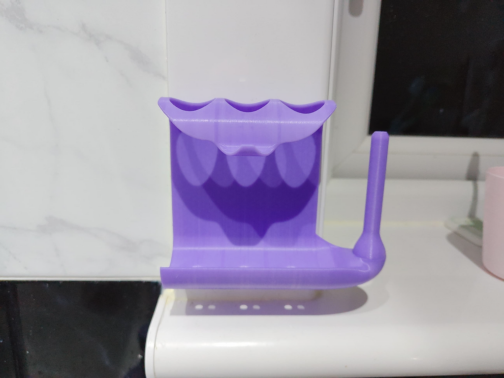 Toothpaste squeezer and toothbrush holder