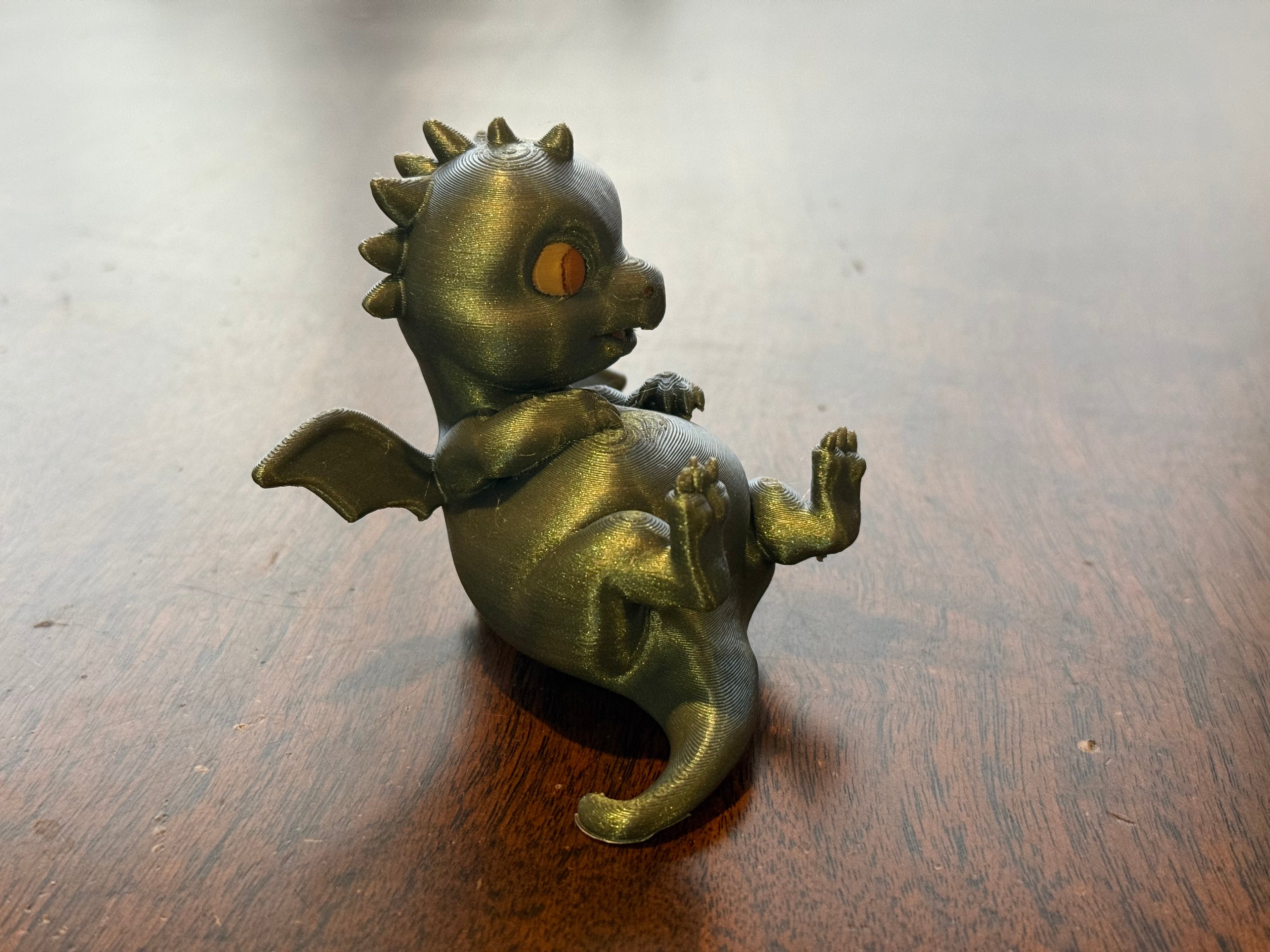 Adorable lounging baby dragon