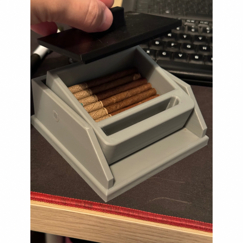 Cigarette box with lift feature